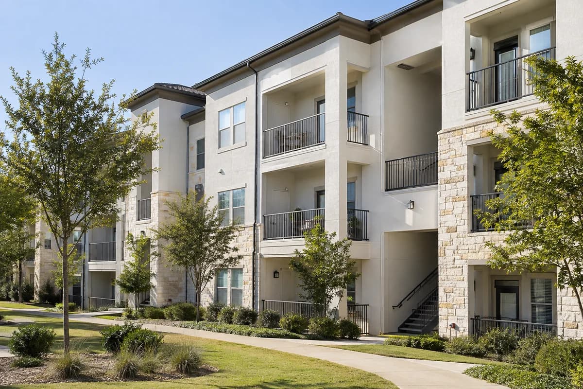Apartment buildings beside a landscaped walkway in daylight